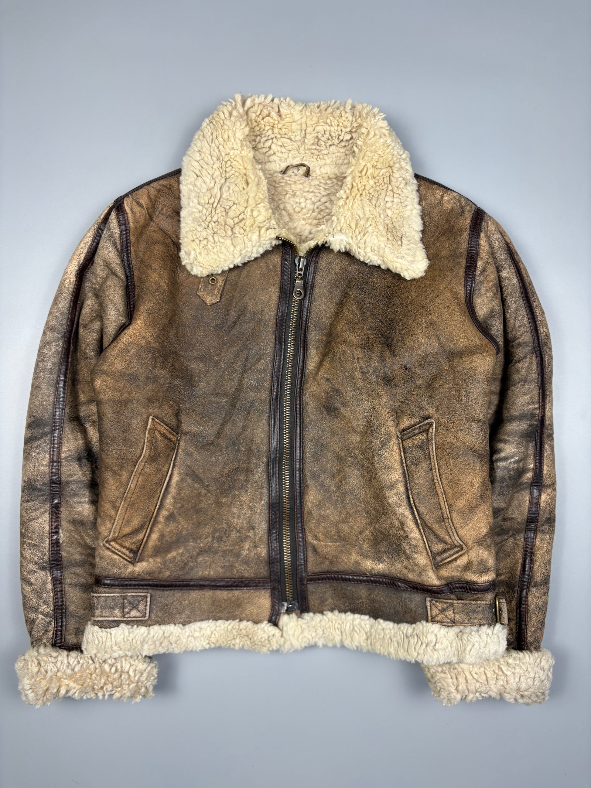 Brown leather jacket with white fur lining on a gray background